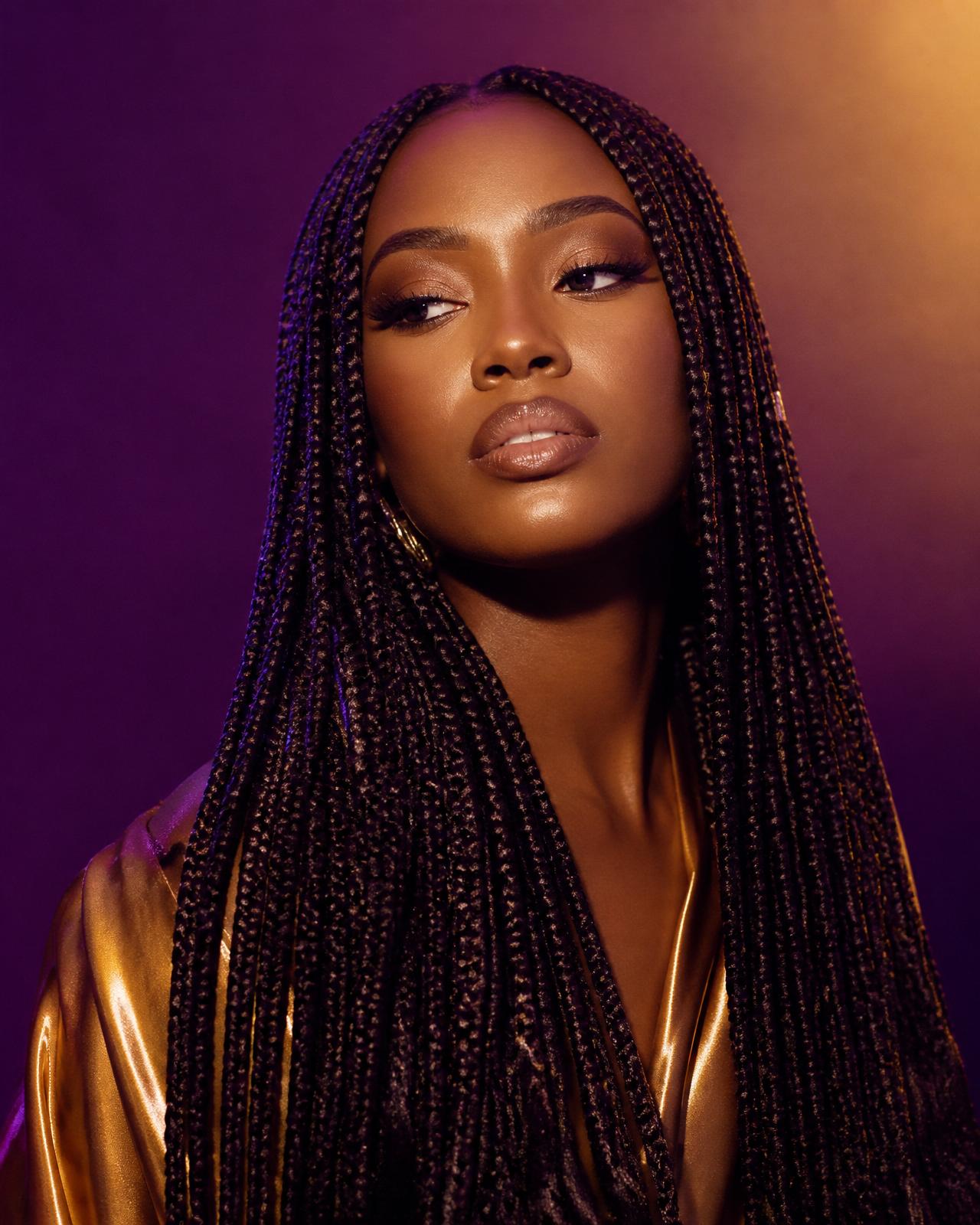 Editorial portrait of a woman wearing long knotless braids